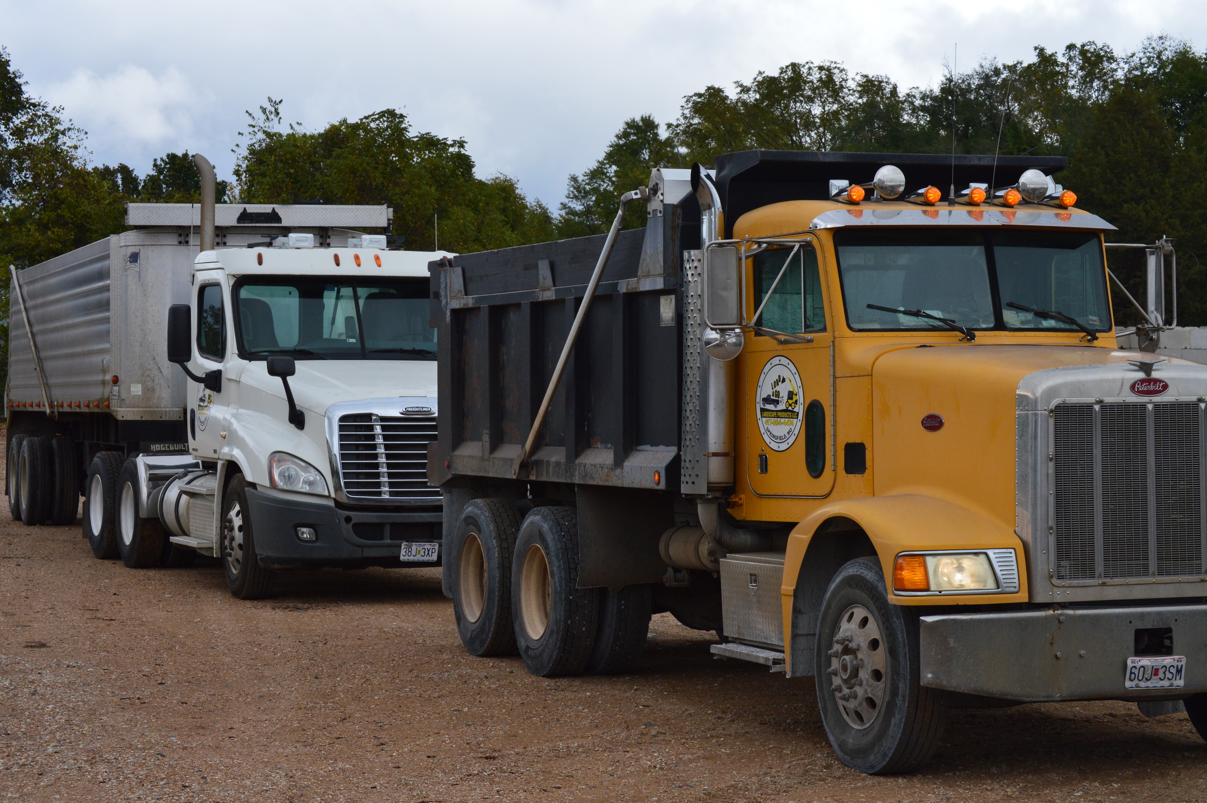 Load & Go commercial trucks including the branded yellow Peterbilt dump truck